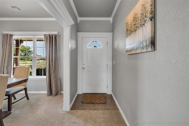 foyer with crown molding and light colored carpet