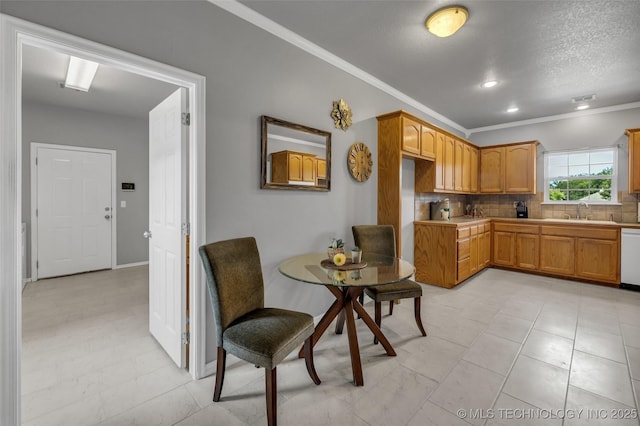 kitchen with dishwasher, sink, backsplash, crown molding, and a textured ceiling