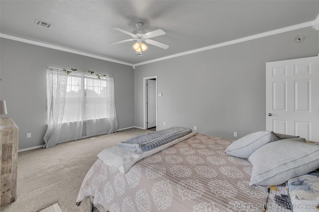 carpeted bedroom with ornamental molding and ceiling fan
