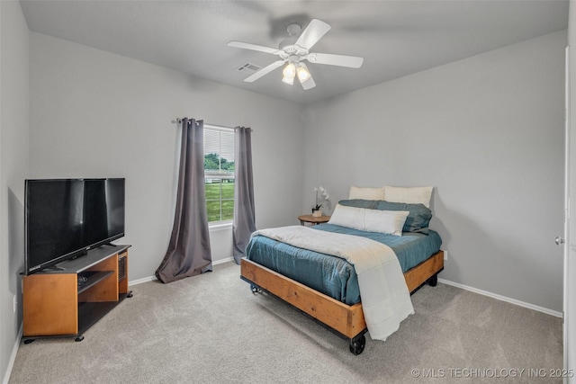 bedroom featuring light carpet and ceiling fan