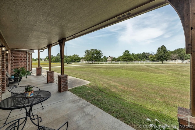 view of yard featuring a rural view and a patio area