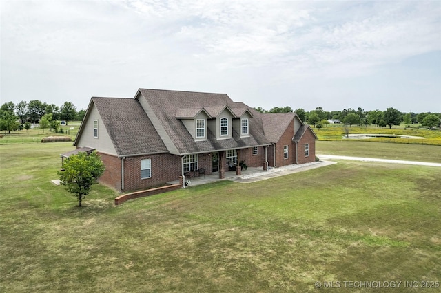 cape cod house with a patio area and a front lawn