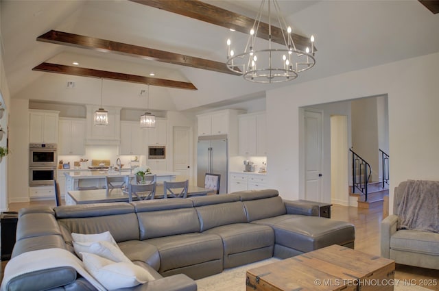 living room with beam ceiling, high vaulted ceiling, and light wood-type flooring