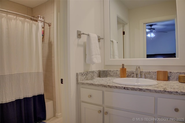 bathroom with vanity, ceiling fan, and shower / bath combo