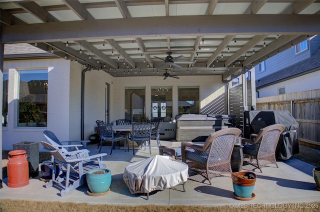 view of patio with area for grilling and ceiling fan