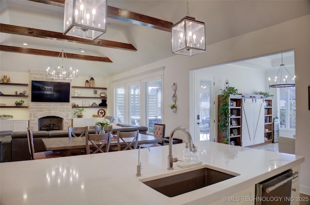 kitchen with sink, a notable chandelier, and decorative light fixtures