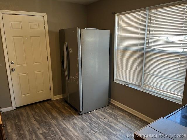 kitchen featuring dark wood-type flooring and stainless steel fridge