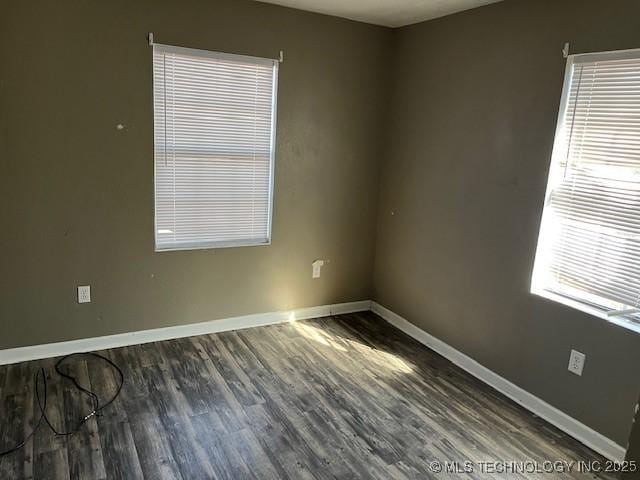 unfurnished room featuring dark hardwood / wood-style flooring