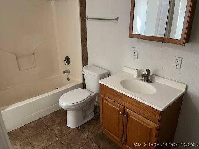 full bathroom featuring vanity, tile patterned flooring, bathing tub / shower combination, and toilet