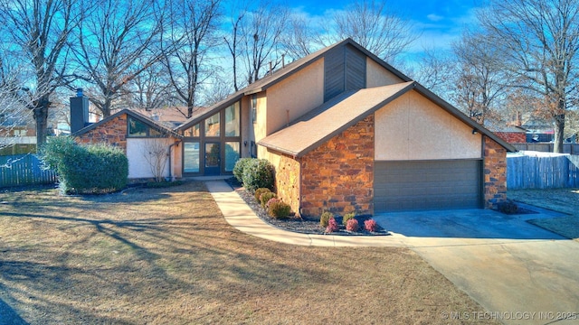 view of front of house featuring a garage and a front yard