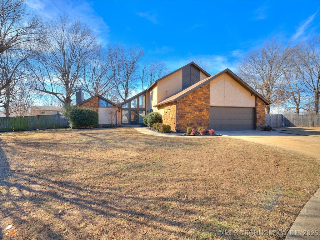 view of side of home with a garage and a yard