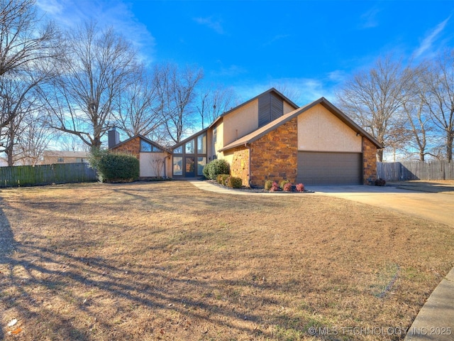 view of side of home with a garage and a yard