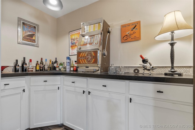 bar featuring white cabinetry and sink