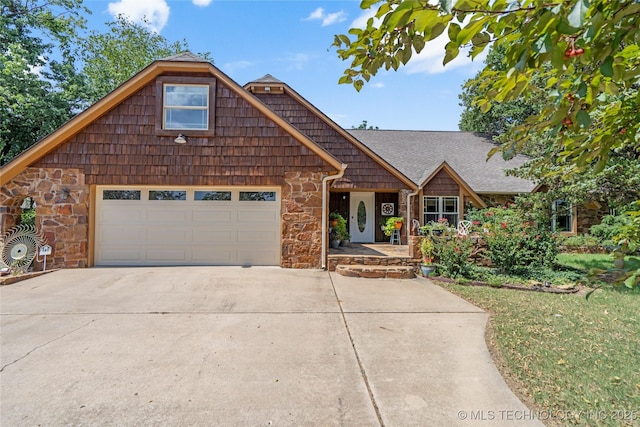 4413 Quail Run, Skiatook, OK 74070 - view of front facade featuring stone siding, concrete driveway, an attached garage, and roof with shingles