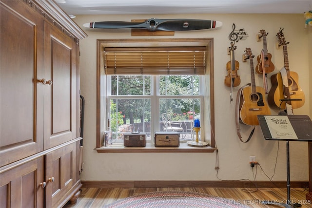 interior space with wood-type flooring and ceiling fan