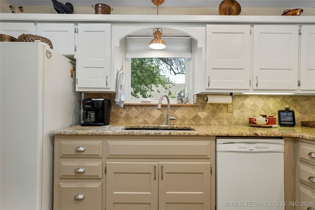 kitchen featuring sink, white cabinets, decorative backsplash, light stone counters, and white appliances