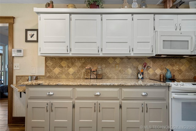 kitchen with white cabinetry, white appliances, and light stone countertops