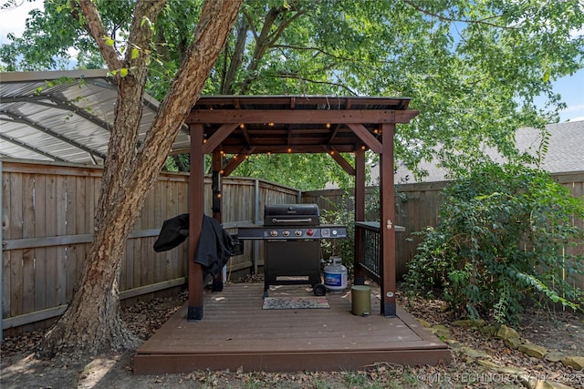 wooden deck featuring a grill