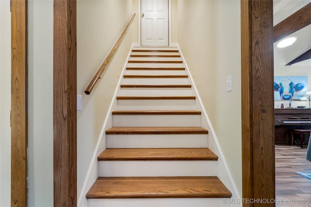 stairs featuring hardwood / wood-style floors