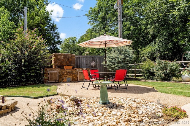 view of patio featuring an outdoor stone fireplace