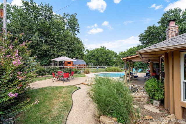 view of yard with a fenced in pool and a patio