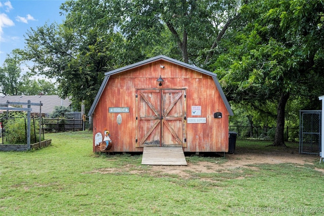 view of outbuilding with a yard