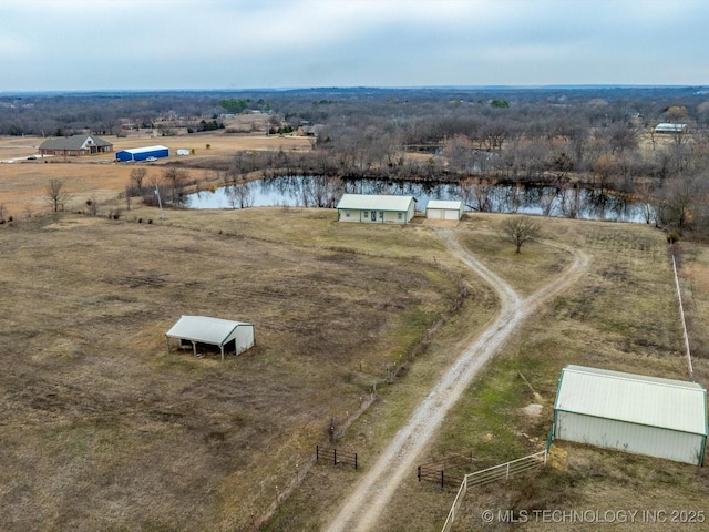 birds eye view of property featuring a rural view and a water view