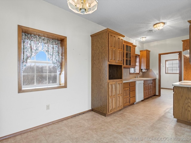 kitchen with dishwasher, an inviting chandelier, and a textured ceiling