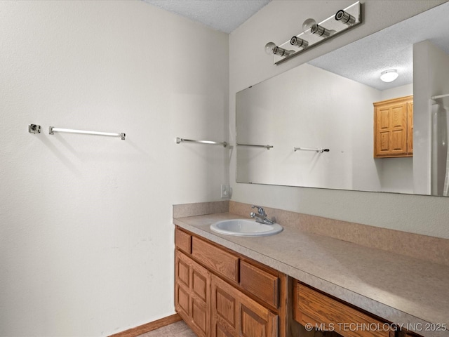 bathroom featuring vanity and a textured ceiling