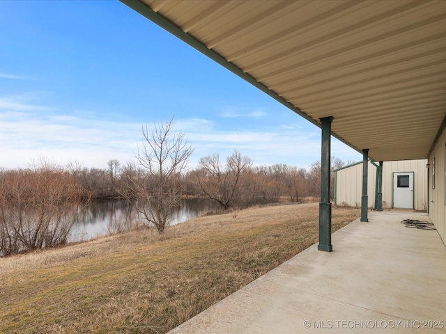 view of yard featuring a water view and a patio area