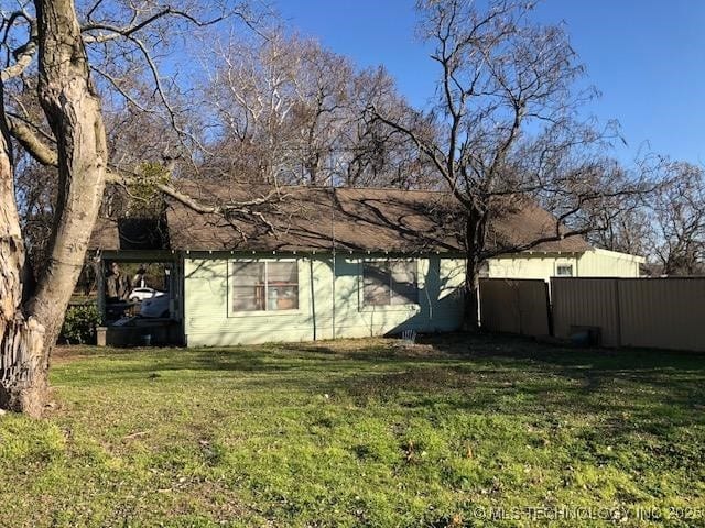 view of side of property featuring a yard