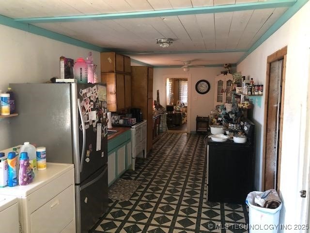 kitchen featuring ceiling fan, stainless steel refrigerator, wood ceiling, and independent washer and dryer