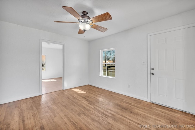 empty room with light hardwood / wood-style flooring and ceiling fan