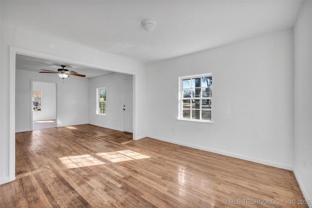 unfurnished room with ceiling fan and light wood-type flooring