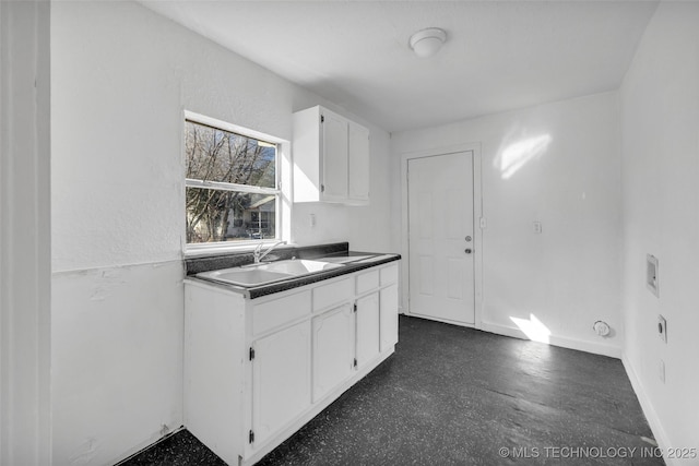 kitchen featuring sink and white cabinets