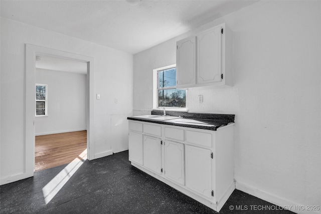 kitchen featuring sink and white cabinets