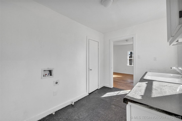 washroom with sink, hookup for a washing machine, cabinets, and hookup for an electric dryer