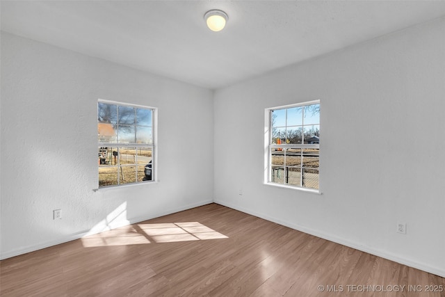 unfurnished room with wood-type flooring