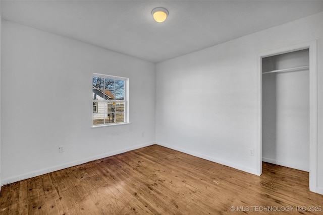 unfurnished bedroom featuring hardwood / wood-style flooring