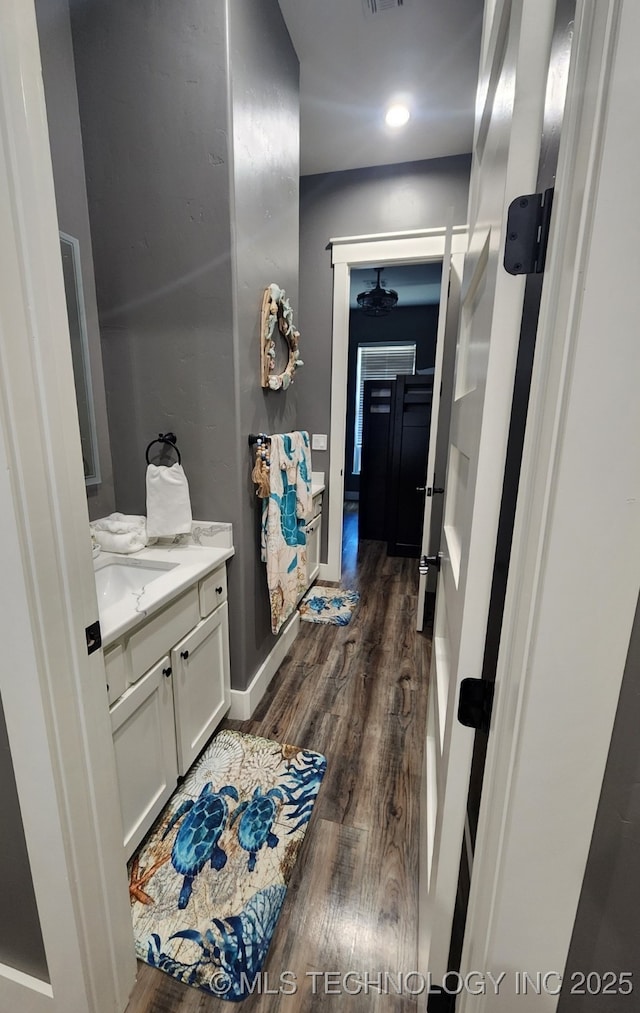 bathroom with hardwood / wood-style flooring and vanity