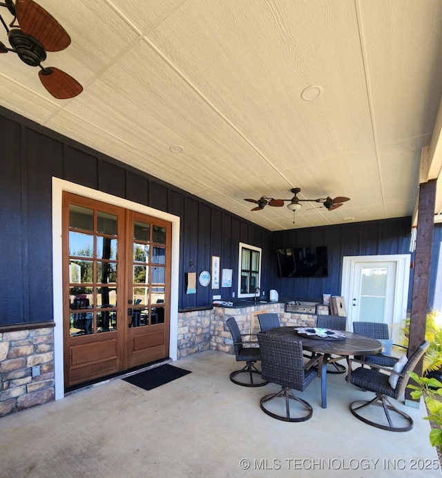 view of patio featuring ceiling fan and french doors