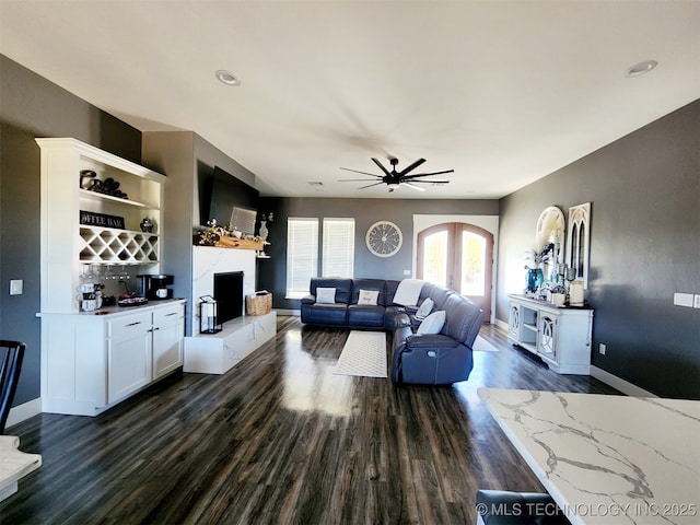 living room with dark hardwood / wood-style floors and ceiling fan