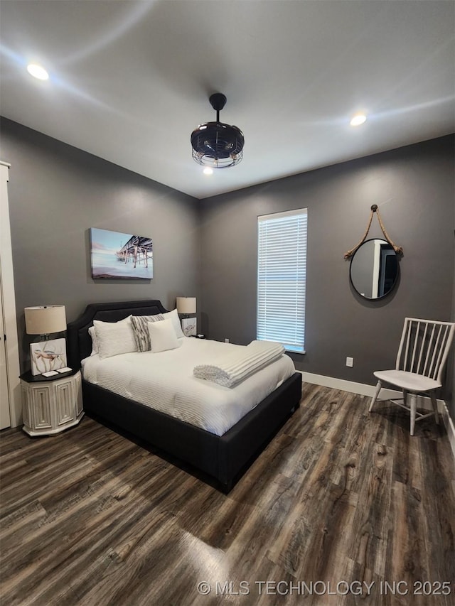 bedroom with dark hardwood / wood-style flooring