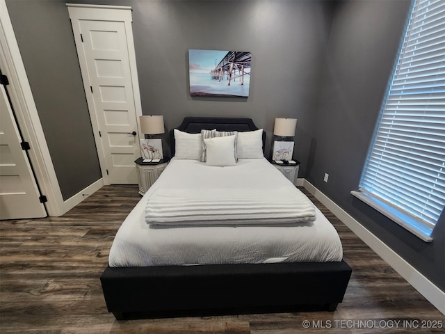 bedroom with dark hardwood / wood-style flooring