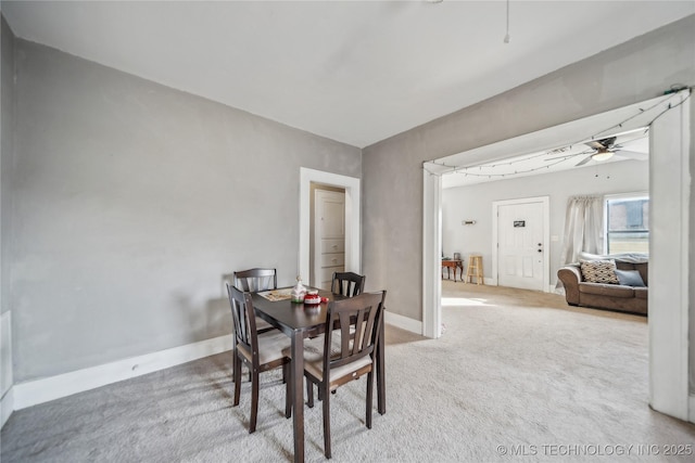 dining area featuring ceiling fan and carpet flooring