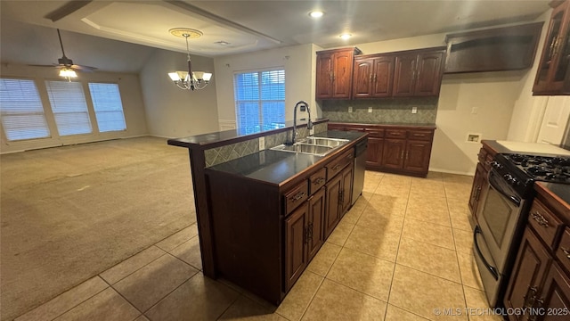 kitchen with sink, appliances with stainless steel finishes, pendant lighting, light colored carpet, and backsplash