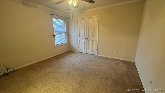 carpeted empty room featuring crown molding and ceiling fan