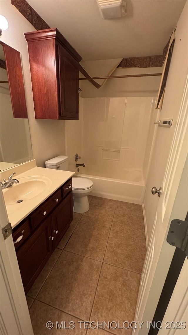 full bathroom with washtub / shower combination, vanity, toilet, and tile patterned flooring