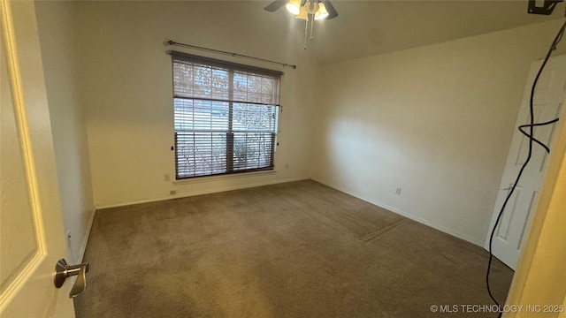 carpeted spare room with ceiling fan