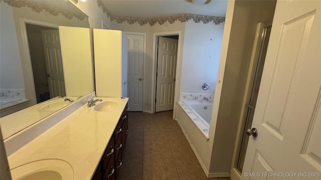 bathroom featuring vanity, a bathtub, and tile patterned flooring